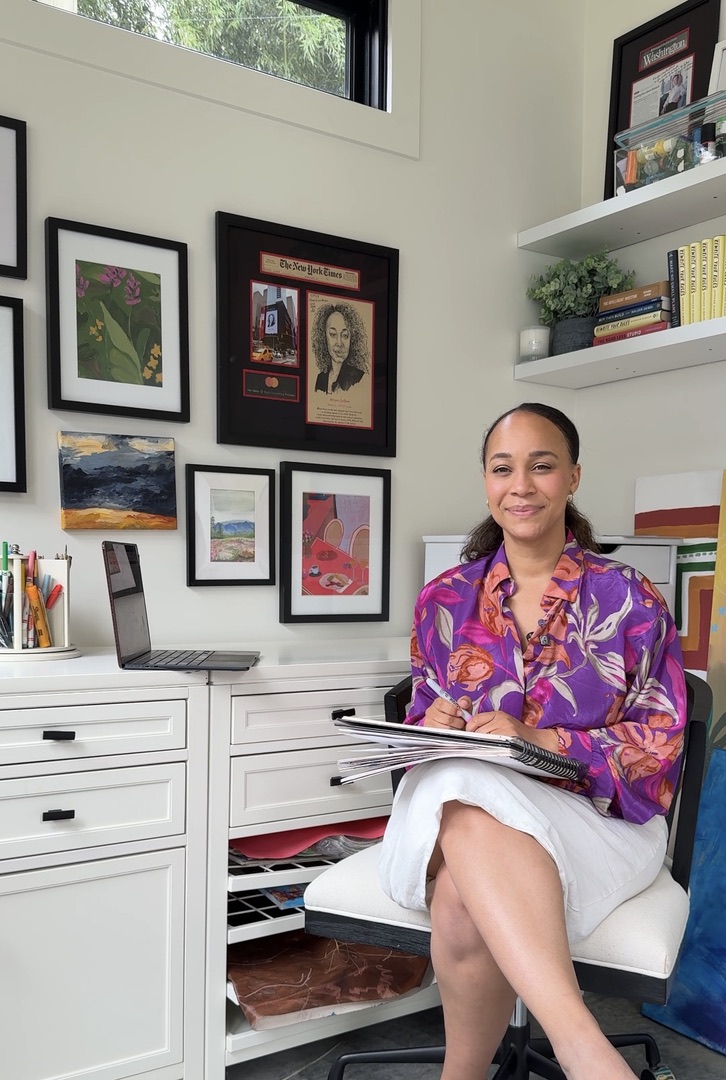 Morgan DeBaun sitting at her desk with a notebook